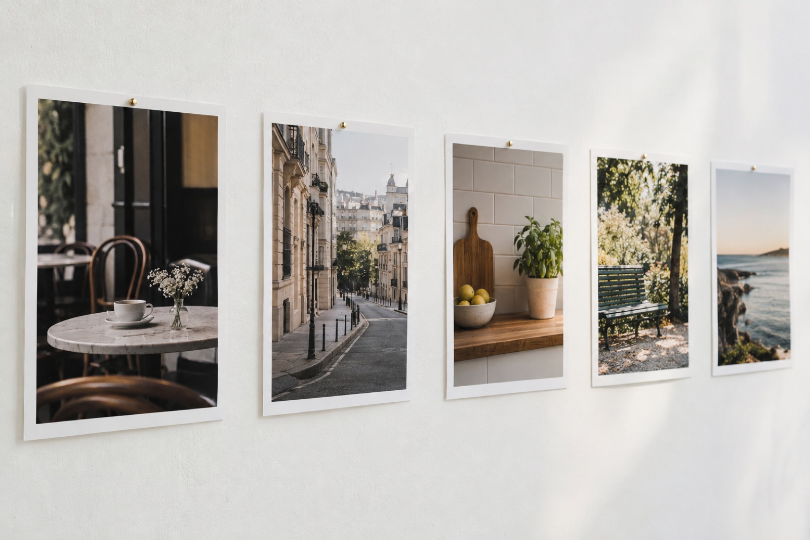 A row of printed photos pinned to a wall, each a different scene: a cafe, a street, a kitchen, a park, soft daylight, no people's faces visible
